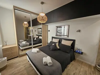 a bedroom with a large bed and a large mirror at PALOMA in Cannes