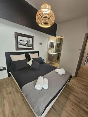 a bedroom with a large bed with two towels on it at PALOMA in Cannes