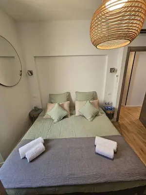 a bedroom with a large bed with two pillows at PALOMA in Cannes