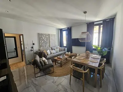 a living room with a couch and a table at PALOMA in Cannes