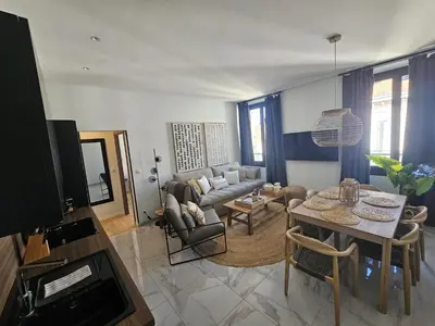 a living room with a couch and a table at PALOMA in Cannes