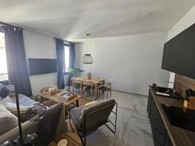 a living room with a couch and a table at PALOMA in Cannes