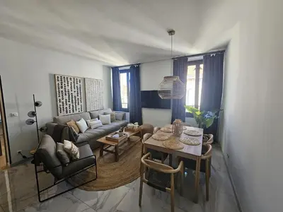 a living room with a couch and a table at PALOMA in Cannes