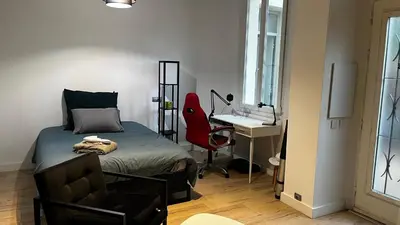 a bedroom with a bed and a desk and a chair at Appartment Cannes City Centre in Cannes