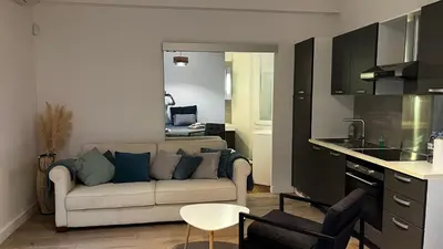 a living room with a couch and a kitchen at Appartment Cannes City Centre in Cannes