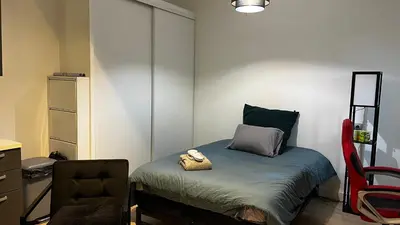 a bedroom with a bed and a desk and a chair at Appartment Cannes City Centre in Cannes