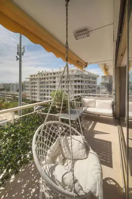 a hammock on a balcony with a view of a building at FRGK 