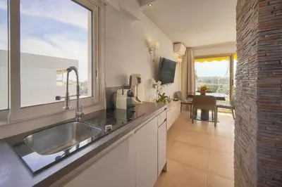 a kitchen with a sink and a large window at FRGK 