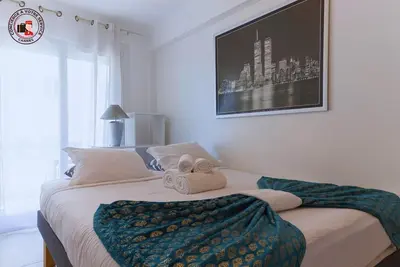 a bedroom with a bed with two towels on it at Lido Sea View, Congrès & Plage, clim, terrasse vue mer in Cannes