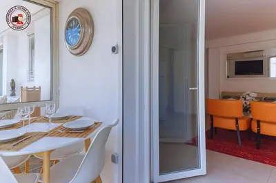 a dining room with a table and a mirror at Lido Sea View, Congrès & Plage, clim, terrasse vue mer in Cannes