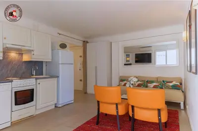 a kitchen and a living room with a table and chairs at Lido Sea View, Congrès & Plage, clim, terrasse vue mer in Cannes