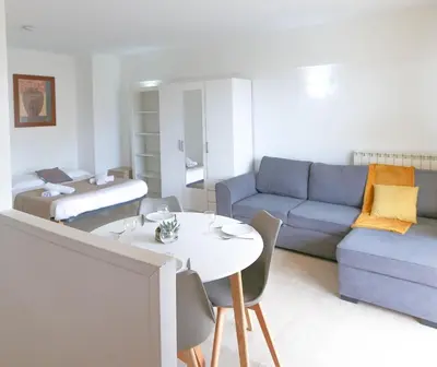 a living room with a couch and a table at Studio with Huge Terrace close to the beach-Clim Mobile- BENAKEY in Cannes