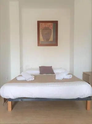 a bed in a room with a picture on the wall at Studio with Huge Terrace close to the beach-Clim Mobile- BENAKEY in Cannes