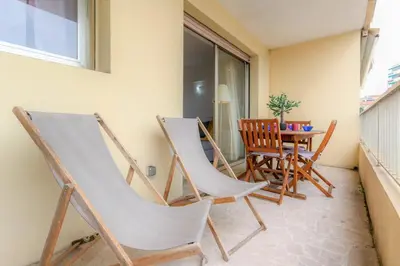 two chairs and a table on a balcony at Studio with Huge Terrace close to the beach-Clim Mobile- BENAKEY in Cannes