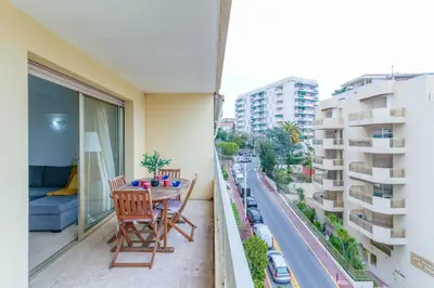 a balcony with a table and chairs and a street at Studio with Huge Terrace close to the beach-Clim Mobile- BENAKEY in Cannes