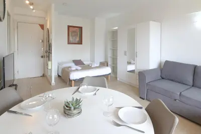 a living room with a white table and a couch at Studio with Huge Terrace close to the beach-Clim Mobile- BENAKEY in Cannes