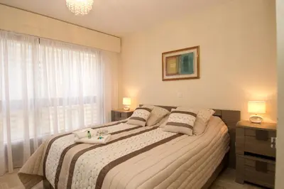 a bedroom with a large bed and a window at GRAY 2a7 in Cannes