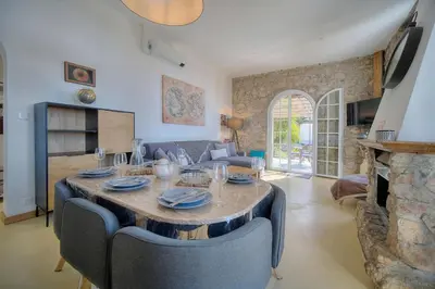 a living room with a table and a couch at IMMOGROOM - T3 - Garden - Quiet - Air conditioning in Cannes