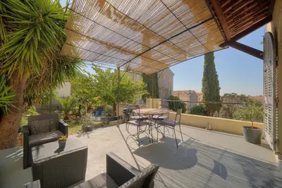 a patio with a table and chairs on a balcony at IMMOGROOM - T3 - Garden - Quiet - Air conditioning in Cannes