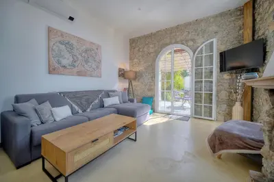a living room with a couch and a table at IMMOGROOM - T3 - Garden - Quiet - Air conditioning in Cannes