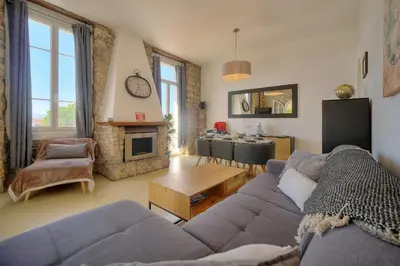 a living room with a couch and a table at IMMOGROOM - T3 - Garden - Quiet - Air conditioning in Cannes