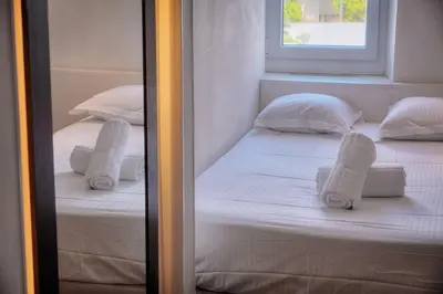 two twin beds in a room with towels on them at IMMOGROOM - T5 de standing - 130m - Terrace - Parking - AC in Cannes