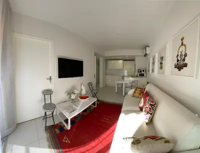 a living room with a white couch and a table at Renovated Cannes Centre Banane balcon in Cannes
