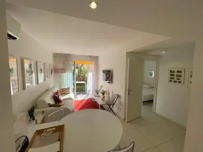 a living room with a table and a couch at Renovated Cannes Centre Banane balcon in Cannes