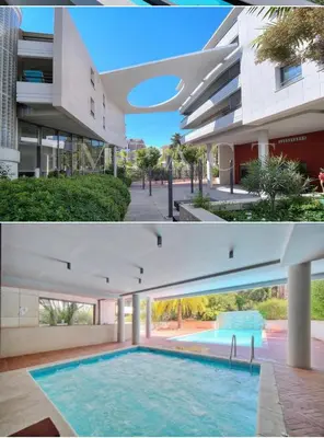 a large swimming pool in front of a building at Appartement , piscine, terrasse, proche croisette in Cannes