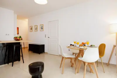 a kitchen and dining room with a table and chairs at Cannes Victoria YourHostHelper in Cannes