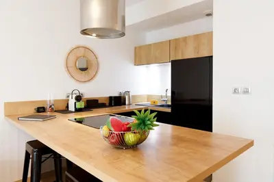 a kitchen with a wooden counter with a bowl of fruit at Cannes Victoria YourHostHelper in Cannes
