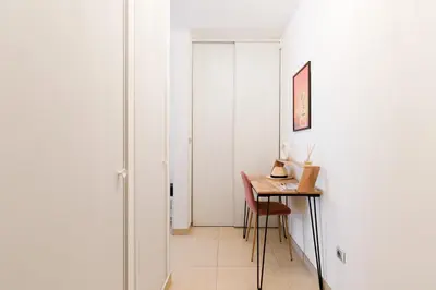 a hallway with a small table and a white wall at Cannes Victoria YourHostHelper in Cannes