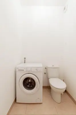 a bathroom with a washing machine and a toilet at Cannes Victoria YourHostHelper in Cannes