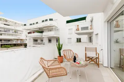 a balcony with two chairs and a table at Cannes Victoria YourHostHelper in Cannes