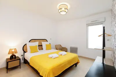 a bedroom with a bed with two towels on it at Cannes Victoria YourHostHelper in Cannes