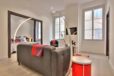 a living room with a couch and a bed at Appartement Cannes 4 chambres - 5G in Cannes