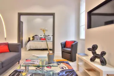 a living room with a couch and a table at Appartement Cannes 4 chambres - 5G in Cannes