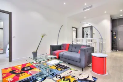 a living room with a couch and a glass table at Appartement Cannes 4 chambres - 5G in Cannes