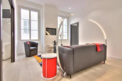 a living room with a couch and a chair at Appartement Cannes 4 chambres - 5G in Cannes