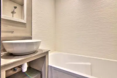 a bathroom with a white sink and a bath tub at Appartement Cannes 4 chambres - 5G in Cannes