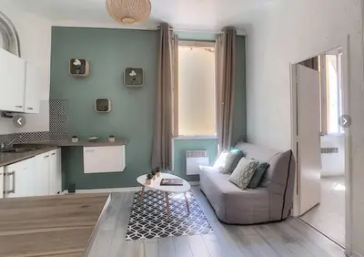 a living room with a couch and a table at Appartement Canne 1 chambre - 21JOFFRE in Cannes