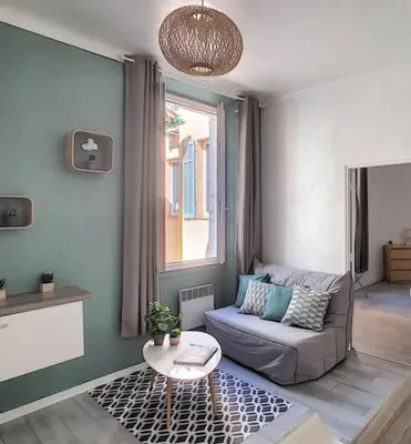a living room with a couch and a table at Appartement Canne 1 chambre - 21JOFFRE in Cannes