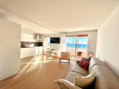 a living room with a couch and a table with chairs at Marjolaine luxury sea view, by Welcome to Cannes in Cannes