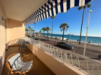 a balcony with a view of the beach and a car at Marjolaine luxury sea view, by Welcome to Cannes in Cannes