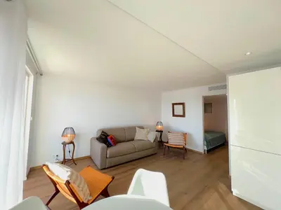 a living room with a couch and a bed at Marjolaine luxury sea view, by Welcome to Cannes in Cannes