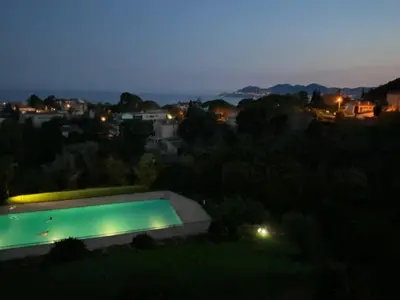 a view of a swimming pool at night at superbe 2 pièces à Cannes vue imprenable in Cannes