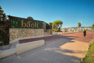 a woman walking down a street next to a building at Jul - Studette - Croisette - VCA in Cannes