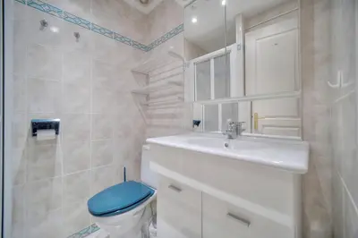 a bathroom with a sink and a toilet and a mirror at Jul - Studette - Croisette - VCA in Cannes
