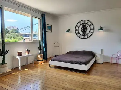a bedroom with a bed and a clock on the wall at FRGK