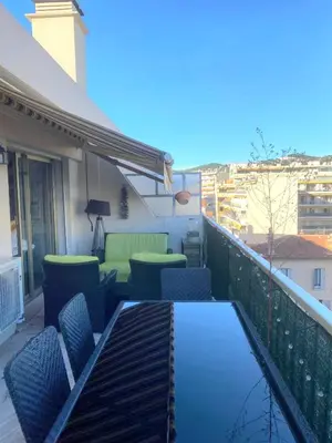 a patio with chairs and a table on a balcony at Beautiful 28m2 studio with balcony in Cannes